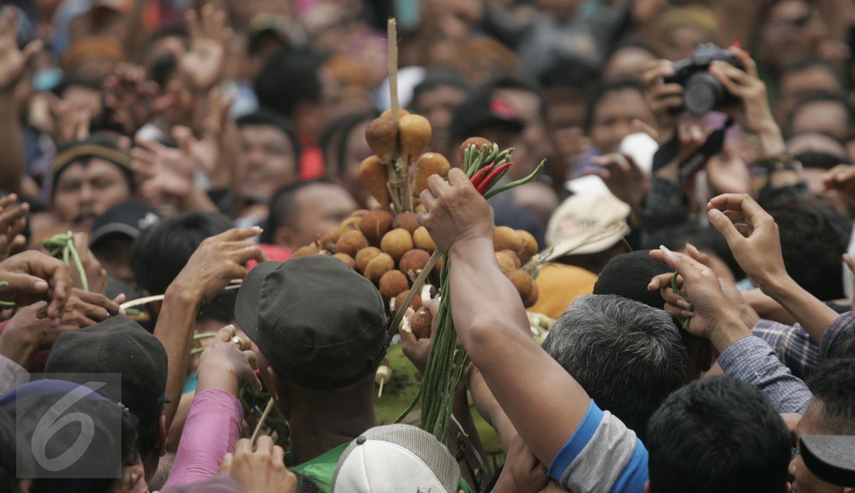 Ratusan warga berebut mendapatkan segala isi dari enam Gunungan Grebeg Mulud di halaman Masjid Agung, Surakarta, Kamis (24/12). Keluarnya gunungan menandai puncak acara Sekaten yang digelar untuk peringatan Maulid Nabi Muhammad. (Boy Harjanto)