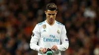 Pemain Real Madrid, Cristiano Ronaldo mengenakan kembali sepatunya pada leg kedua perempat final Liga Champions di Santiago Bernabeu, Rabu (11/4). Ronaldo menendang sepatunya ke udara setelah dijegal bek Juventus, Stephan Lichsteiner. (AP /Francisco Seco)
