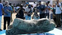 Orang-orang mengabadikan foto artefak yang ditemukan dari Laut Mediterania di Teluk Abu Qir di Alexandria, Mesir, pada 21 Agustus 2025. (Dok. Xinhua/Sui Xiankai)