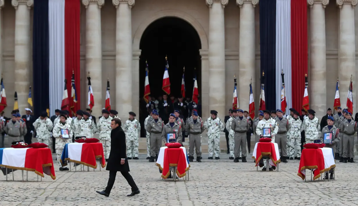 Presiden Prancis Emmanuel Macron menghadiri upacara pemakaman 13 tentara Prancis yang tewas dalam kecelakaan helikopter di Mali, Paris, Senin (2/12/2019). Sebanyak 13 tentara tewas setelah dua helikopter yang ditumpangi bertabrakan dalam operasi melawan miltan di Mali. (AP Photo/Thibault Camus,Pool)