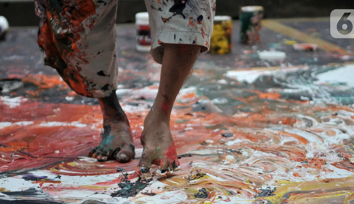 Sadikin Pard (53) membuat karya lukisan dengan kedua kakinya saat Indonesian Art Festival "Pesta Seni Rupa Indonesia" di Museum Nasional, Jakarta, Minggu (10/11/2019). Sadikin Pard membuktikan karyanya yang telah merambah ke kancah internasional. (merdeka.com/Iqbal S. Nugroho)