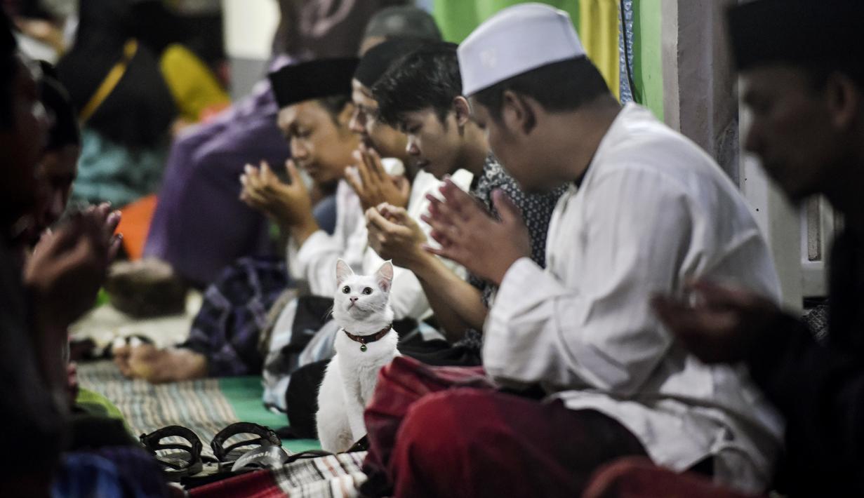 Malam hari pun di tempat salah satu korban lainnya, Ahmad Fajar Khoiron yang juga menjadi korban tewas dalam Tragedi Kanjuruhan dilakukan Tahlilan dengan membaca Surat Yasin untuk mendoakan almarhum. (AP/Dicky Bisinglasi)
