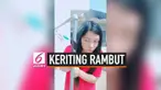 Seorang wanita menggunakan pipa air yang berada di luar rumah untuk mengeriting rambut. Ia melakukannya saat suhu mencapai 30 derajat celcius di China.
