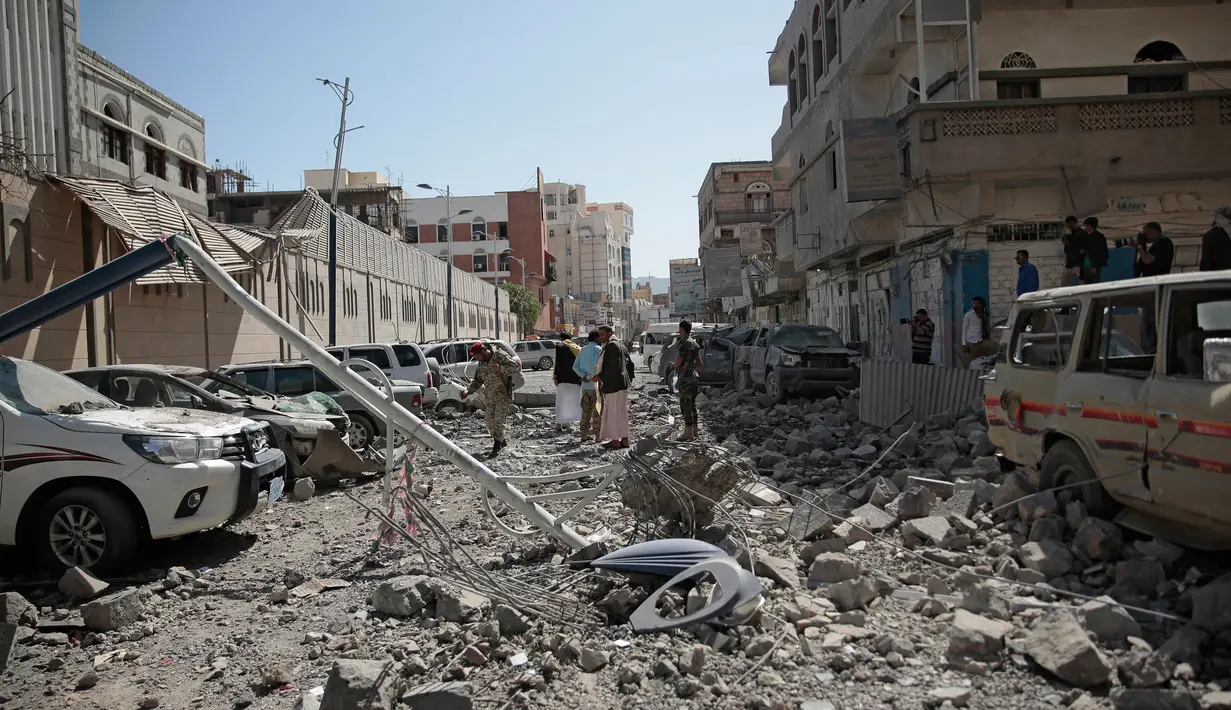 Petugas keamanan setempat memeriksa di sekitar lokasi terjadi serangan udara di kompleks kepresidenan, di Sanaa, Yaman (7/5). (AP Photo/Hani Mohammed)