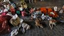Perempuan India menjual karangan bunga di sebuah jembatan di Kolkata, 11 Maret 2016. Beberapa orang di Kolkata bekerja sebagai penjual pakaian bekas atau pengemudi becak dan mereka terlalu miskin untuk membeli rumah. (REUTERS/Rupak De Chowdhuri)