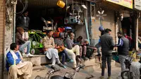 Pemilik toko dan pekerja menunggu listrik menyala menyusul gangguan listrik nasional di pasar di Lahore, Pakistan, Senin (23/1/2023). Pemadaman listrik dilaporkan sampai mengganggu operasional pabrik-pabrik, rumah sakit (RS), hingga sekolah-sekolah di semua kota utama Pakistan. (AP Photo/K.M. Chaudary)