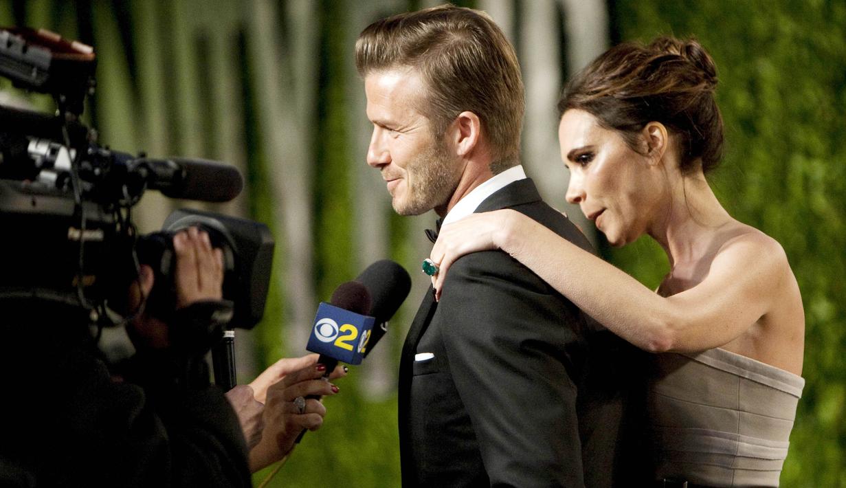 Legenda Timnas Inggris, David Beckham, bersama istrinya, Victoria Beckham, memberikan keterangan kepada wartawan saat menghadiri acara Vanity Fair Oscar Party di  Sunset Tower, California, Amerika Serikat (26/2/2012). (Photo by ADRIAN SANCHEZ-GONZALEZ / AFP)