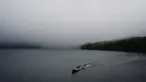 Dua pria mengendarai perahu di atas Danau Ashi di perfektur Kanagawa, Jepang (11/9/2019). Danau Ashi adalah sebuah sebuah danau cantik yang terletak pada wilayah Taman Nasional Hakone di Prefektur Kanagawa, Jepang. (AFP Photo/Charly Triballeau)