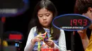Seorang anak perempuan serius memecahkan permainan rubik pada kejuaraan kubus Rubik Dunia di Melbourne, Australia (12/7/2019). Kejuaraan Dunia diadakan setiap dua tahun dan telah menarik 905 pesaing dari seluruh dunia yang bersaing dalam 18 acara yang berbeda. (AFP Photo/William West)