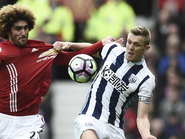 Gelandang Manchester United, Marouane Fellaini, berebut bola dengan Gelandang, West Bromwich Albion, Darren Fletcher dalam lanjutan Liga Inggris di Stadion Old Trafford, Manchester, Sabtu (1/4/2017). Laga tersebut berakhir 0-0. (AFP/Oli Scarff)