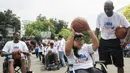 Perwakilan NBA Asia, Chris Sumner, menyemangati seorang penyandang disabilitas untuk melempar bola. (Bola.com/Vitalis Yogi Trisna)