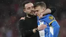 Pelatih kepala Brighton, Roberto De Zerbi (kiri) memberikan pelukan kepada pemainnya, Solly March setelah gagal mengeksekusi tendangan penalti pada laga semifinal Piala FA 2022/2023 di Stadion Wembley, London, Minggu (23/04/2023). Laga dimenangkan oleh MU dengan skor 7-6. (AP Photo/Kirsty Wigglesworth)