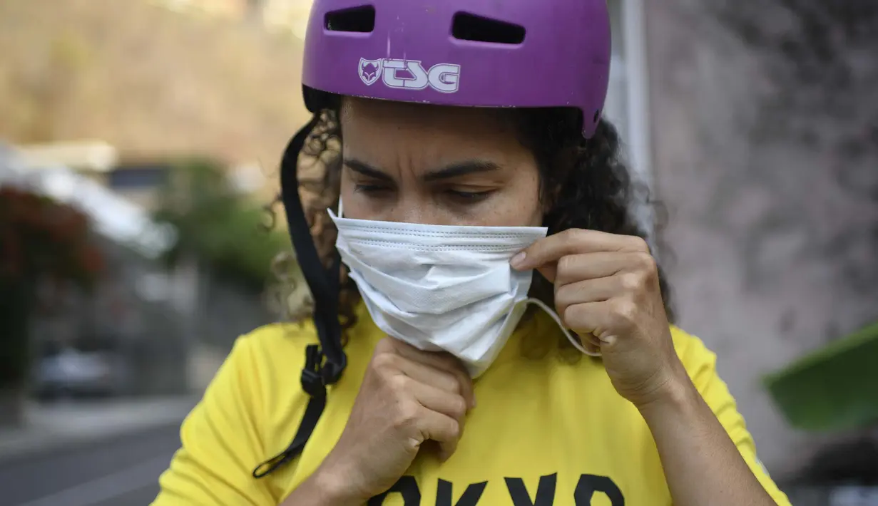 Atlet BMX asal Venezuela, Stefany Hernandez mengenakan masker sebelum latihan di Caracas, 25 April 2020. Di tengah karantina wilayah guna mengekang penyebaran Covid-19, peraih medali Olimpiade 2016 itu berlatih tiga kali seminggu untuk meraih tiket tampil di Olimpiade 2021. (AP/Matias Delacroix)