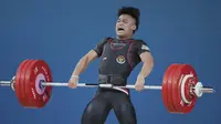 Rizki Juniansyah berhasil meraih medali emas untuk Indonesia dari nomor 73 kg putra angkat besi Olimpiade 2024, Jumat (9/8/2024) dini hari WIB. (AP Photo/Kin Cheung)