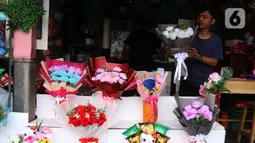 Penjual tengah menata bunga mawar di kawasan Rawa Belong, Jakarta, Senin (14/2/2022). Hari Valentine yang diperingati setiap 14 Februari menjadi berkah bagi para penjual bunga karena banyak pesanan bunga di momen kasih sayang tersebut. (Liputan6.com/Angga Yuniar)