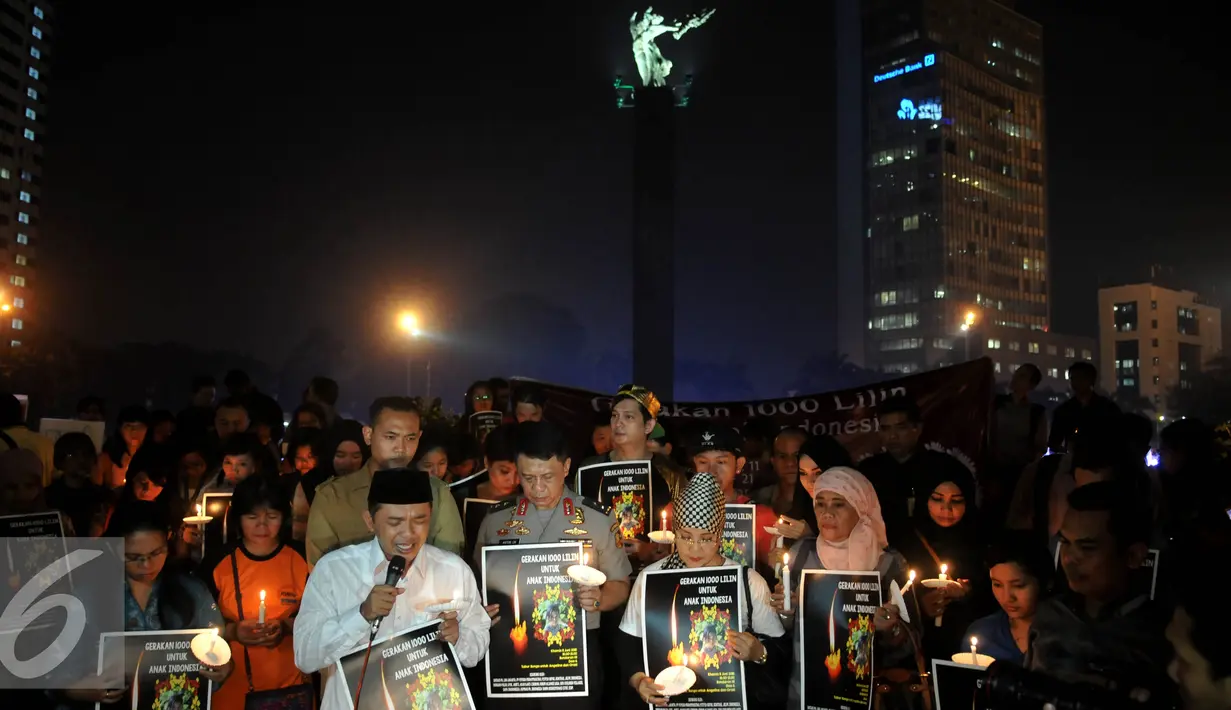 Aksi simpatik dan doa bersama untuk Angeline dengan menyalakan lilin di Bundaran HI, Jakarta, Kamis (11/6/2015). Mereka meminta pemerintah bersikap tegas kepada pelaku kekerasan anak. (Liputan6.com/Johan Tallo)
