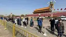 Orang-orang membungkuk di depan Gerbang Tiananmen di Beijing selama peringatan nasional tiga menit untuk memperingati orang yang meninggal dalam wabah coronavirus COVID-19, di Beijing (4/4/2020). (AFP/Leo Ramirez)