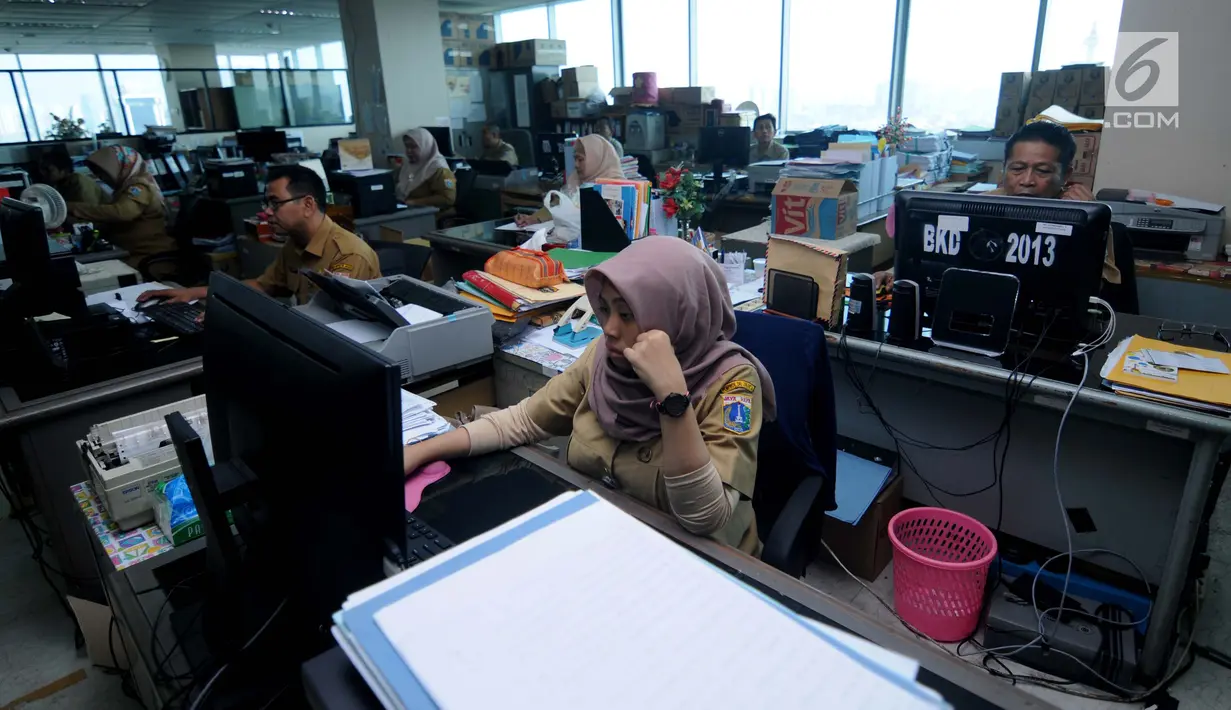 Sejumlah Pegawai Negeri Sipil (PNS) Pemerintahan Provinsi DKI Jakarta melakukan aktivitas kerja pertama usai libur Lebaran di Balai Kota, Jakarta, Senin (3/7). (Liputan6.com/Gempur M Surya)