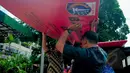 Petugas Penataan Kota DKI Jakarta membawa spanduk segel Mal Tebet Green karena belum memiliki sertifikat Surat Layak Fungsi (SLF), Jakarta, Kamis (5/3/2015). Penyegelan ini merupakan peringatan ketiga untuk mal Tebet Green. (Liputan6.com/Yoppy Renato)