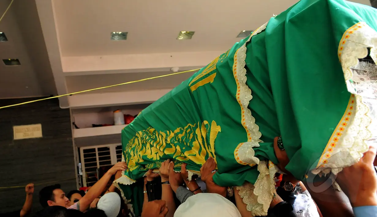 Mobil ambulan yang membawa jenazah Olga Syahputra tiba di rumah duka pukul 9.45 WIB, Jakarta, Sabrtu (28/3/2015). Tampak keranda jenazah Olga Syahputra digotong oleh banyak orang (Liputan6.com/Faisal R Syam)