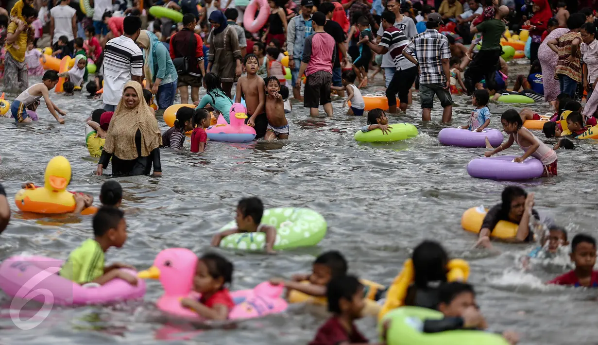 Sejumlah anak bermain di pantai Ancol, Jakarta, Minggu (25/12). Warga Jakarta dan sekitarnya memanfaatkan liburan panjang untuk rekreasi bersama keluarga di Ancol. (Liputan6.com/Faizal Fanani)