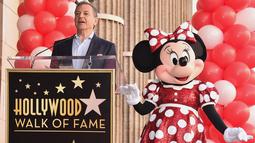 Bos Walt Disney, Bob Iger memberikan sambutan di samping Minnie Mouse saat menerima penghargaan Hollywood Walk of Fame atas nama Minnie Mouse di Los Angeles, Senin (22/1). (Alberto E. Rodriguez/GETTY IMAGES NORTH AMERICA/AFP)