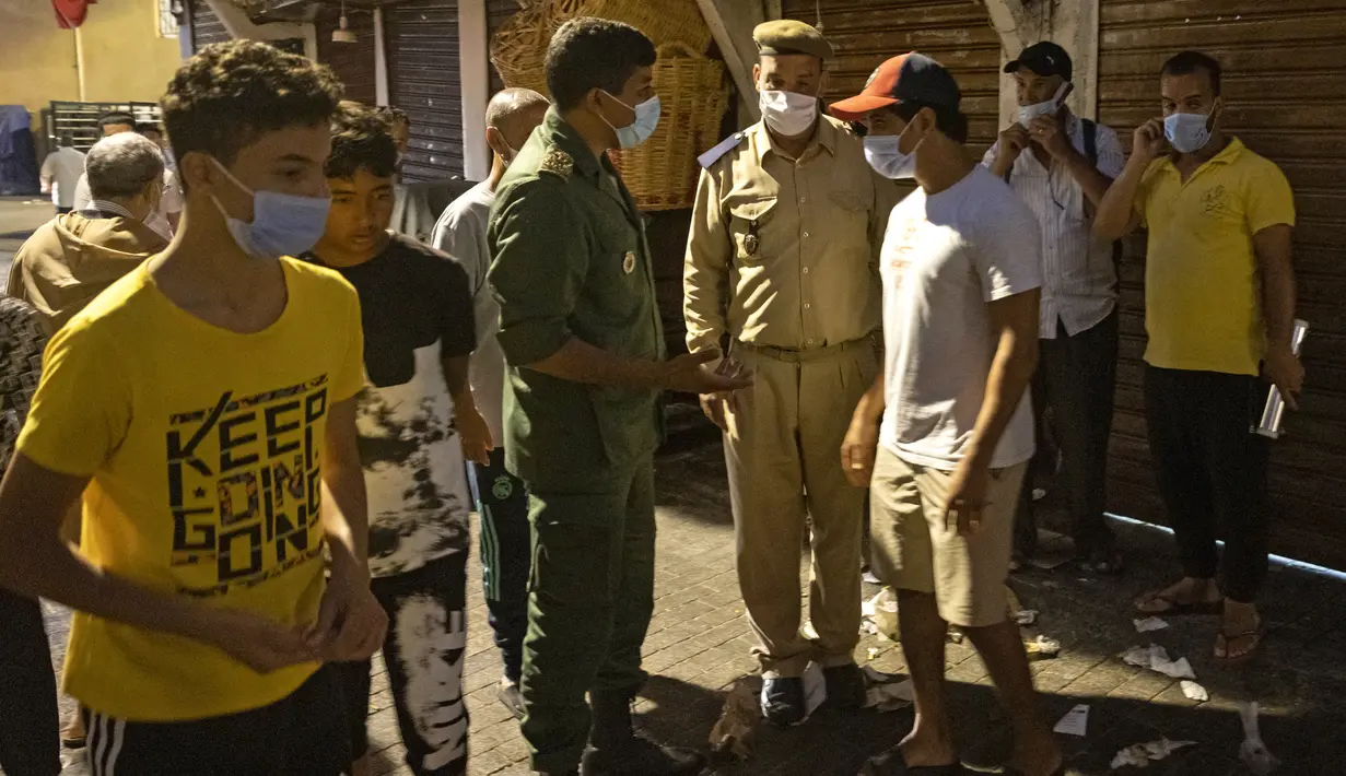 Pasukan keamanan Maroko memastikan penutupan toko dan meminta orang untuk kembali ke rumah di ibu kota Rabat pada Rabu (3/8/2021). Maroko memperpanjang jam malam dan memperketat pembatasan perjalanan ke tiga kota besar dalam upaya memperlambat lonjakan kasus corona COVID-19. (FADEL SENNA / AFP)