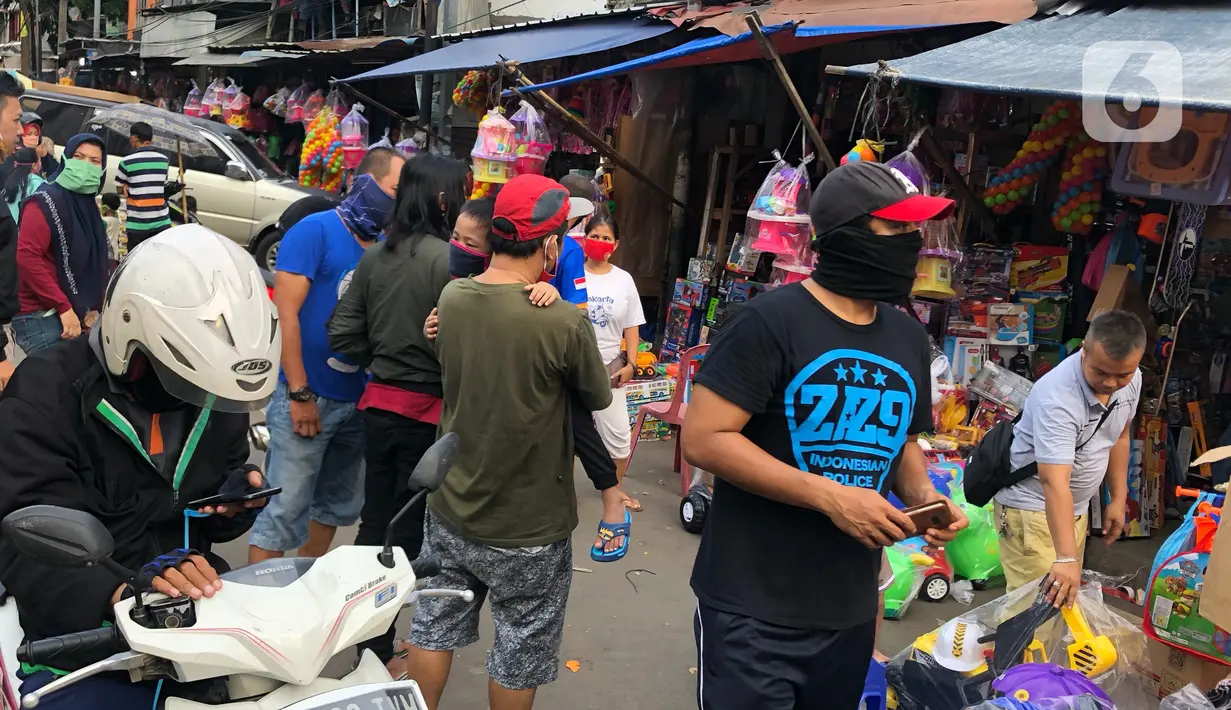 Warga memilih mainan tanpa menjaga jarak di Pasar Gembrong, Jakarta Timur, Minggu (31/5/2020). Meski penerapan masa Pembatasan Sosial Berskala Besar (PSBB) di Jakarta masih berlaku, namun pasar yang khusus menjual pernak-pernik mainan anak ini kembali dipadati warga. (Liputan6.com/Immanuel Antonius)