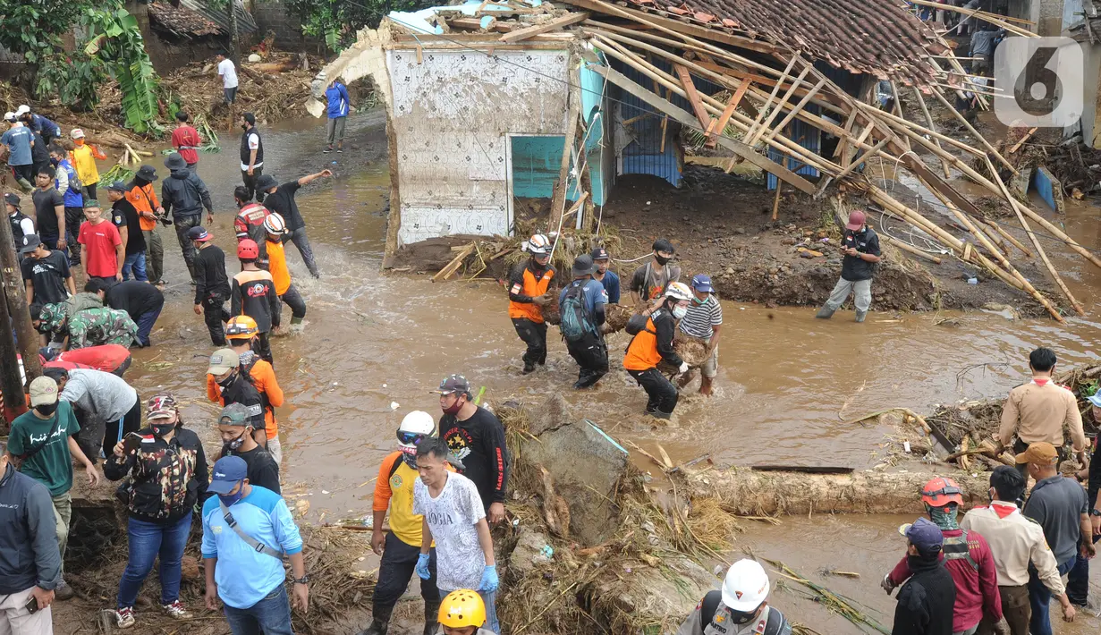 Tim SAR gabungan TNI, Polri, dan relawan membersihkan material longsor usai banjir bandang menerjang Kampung Cibuntu, Desa Pasawahan, Kecamatan Cicurug, Sukabumi, Selasa (22/9/2020). Banjir mengakibatkan puluhan bangunan rusak berat, 12 rumah hanyut, dan dua korban hilang. (merdeka.com/Arie Basuki)