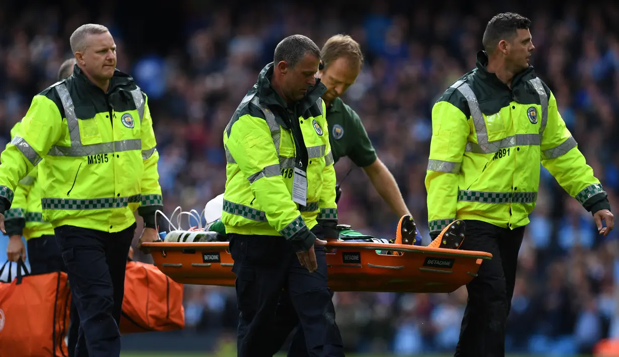 Kiper Manchester City, Ederson dibwa keluar lapangan dengan tandu usai wajahnya dihantam kaki pemain Liverpool Sadio Mane saat pertandingan Liga Inggris di Stadion Etihad, Manchester (9/9). (AFP Photo/Paul Ellis)