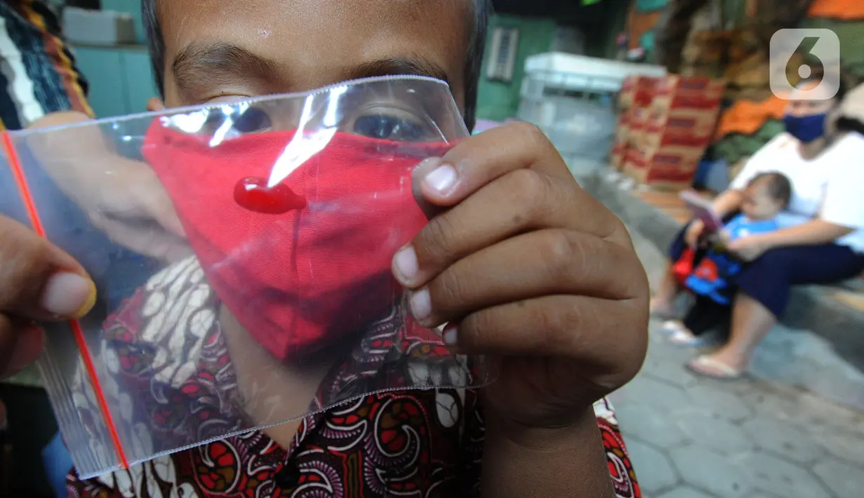 Balita memperhatikan vitamin A yang diberikan saat pelaksanaan Posyandu di Pos Ronda Kampung Kebon Jukut RW 10, Kelurahan Babakan Pasar, Kota Bogor, Kamis (6/8/2020). Kegiatan Posyandu untuk pertama kalinya selama pandemi corona ini bertepatan dengan pemberian vitamin A. (merdeka.com/Arie Basuki)
