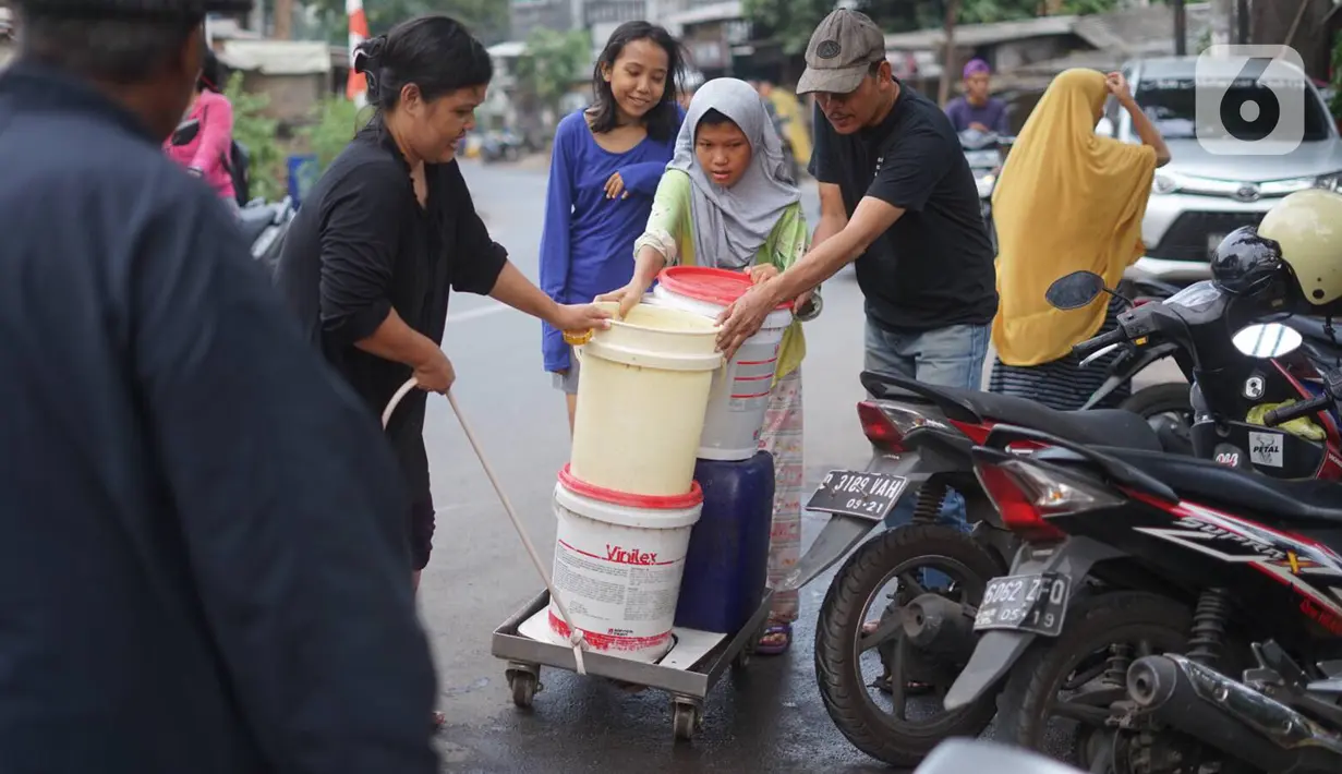 Warga membawa ember berisi air bersih di kawasan Cipayung, Jakarta Timur, Rabu (20/11/2019). Hingga kini masyarakat terdampak masih mengandalkan bantuan pasokan air bersih yang disediakan Pemprov DKI Jakarta. (Liputan6.com/Immanuel Antonius)