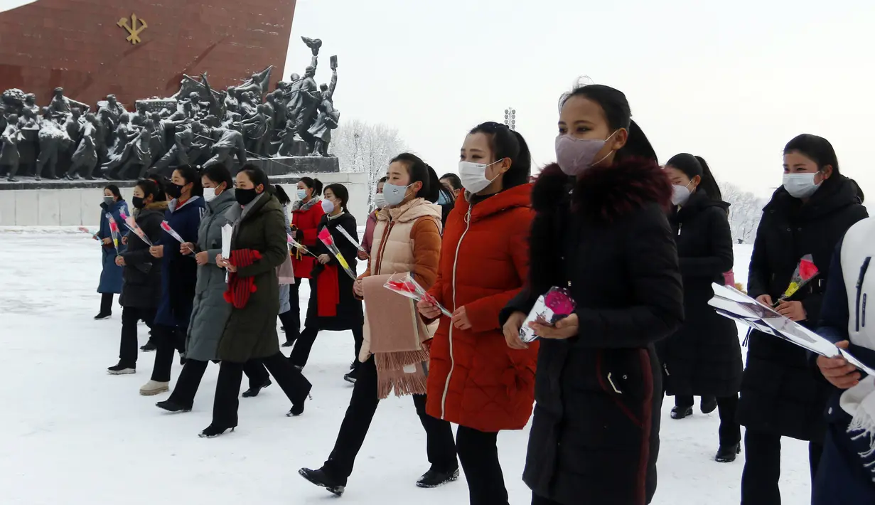 Orang-orang mengunjungi patung mantan pemimpin Korea Utara Kim Il Sung dan Kim Jong Il di Bukit Mansu di Pyongyang, Korea Utara, pada kesempatan liburan Tahun Baru Imlek, Selasa (1/2/2022). (AP Photo/Jon Chol Jin)