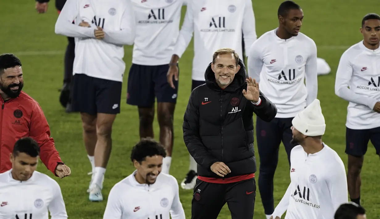 Pelatih Paris Saint-Germain (PSG),  Thomas Tuchel tersenyum saat berbicara dengan pemainnya selama latihan tim di Jan Breydel Stadium di Bruges (21/10/2019). PSG akan bertanding pada matchday ketiga Grup A Liga Champions melawan wakil Belgia, Club Brugge. (AFP Photo/Kenzo Tribouillard)