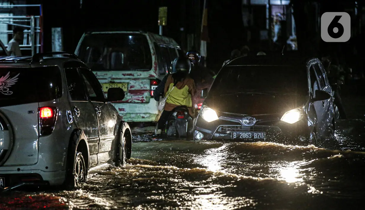 Sejumlah kendaraan terjebak banjir di Jalan Ciracas Raya, Jakarta, Jumat (12/8/2022). Hujan lebat yang terjadi sore tadi membuat Jalan Ciracas Raya tergenang air dan kendaraan terjebak banjir. (Liputan6.com/Faizal Fanani)