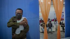 Petugas polisi menekan lengannya setelah menerima vaksinasi COVID-19 dosis ketiga di rumah sakit pemerintah di Gauhati, India (10/1/2022). India pada Senin (10/1) mulai memberikan dosis penguat (booster) vaksin COVID-19 bagi pekerja di lini depan dan lansia yang rentan.  (AP Photo/Anupam Nath)