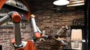 Foto yang diambil pada 1 Juli 2021 menunjukkan "Pazzi", robot pembuat pizza yang sedang bekerja di sebuah restoran di Paris. Setiap pizza umumnya hanya membutuhkan waktu sekitar lima menit untuk disiapkan dan dipanggang. (BERTRAND GUAY/AFP)