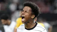 Penyerang Jerman, Karim Adeyemi berselebrasi usai mencetak gol ke gawang Armenia pada pertandingan grup J Kualifikasi Piala Dunia 2022 di stadion Mercedes-Benz Arena di Stuttgart, Jerman, Senin (6/9/2021). Jerman kini berada di puncak klasemen dengan poin 12. (AP Photo/Matthias Schrader)