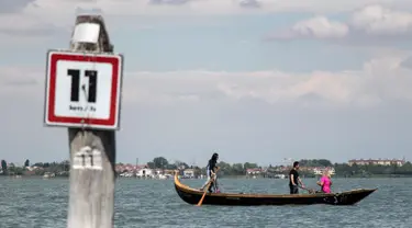 Perempuan yang tergabung dalam Row Venice menawarkan pengalaman belajar mendayung gondola di sebuah kanal di Venesia, Italia pada 16 Mei 2019. Row Venice merupakan organisasi nonprofit bentukan sekelompok perempuan yang berfokus pada pelestarian seni mendayung perahu. (MARCO BERTORELLO/AFP)