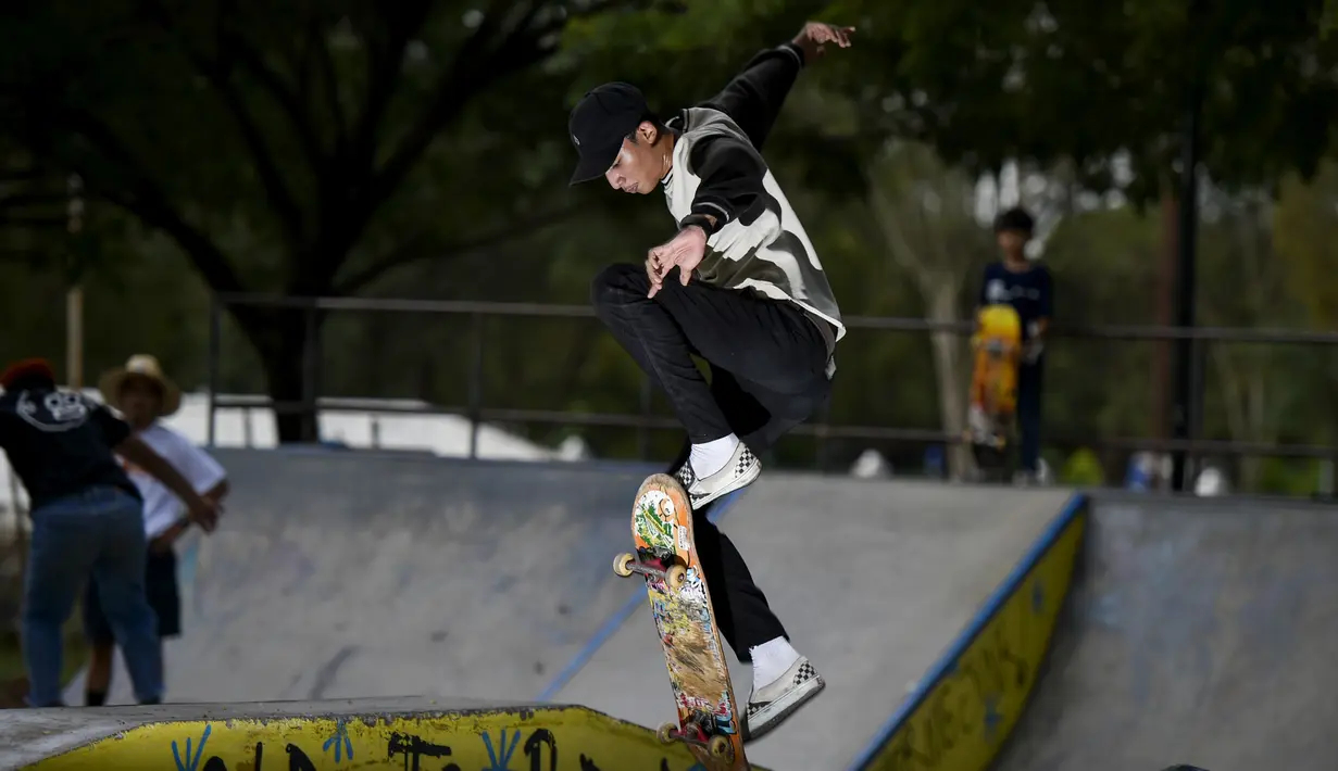 Seorang pemain skateboard melakukan trik di taman skate di Banda Aceh  (8/11/2020). (AFP/Chaideer Mahyuddin)