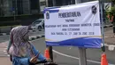 Warga melihat spanduk pemberitahuan peniadaan pelaksanaan Hari Bebas Kendaraan Bermotor (HBKB) di sekitar Bundaran Hotel Indonesia, Jakarta, Minggu (3/6). Pelaksanaan HBKB akan ditiadakan pada 10, 17, dan 24 Juni 2018. (Liputan6.com/Helmi Fithriansyah)