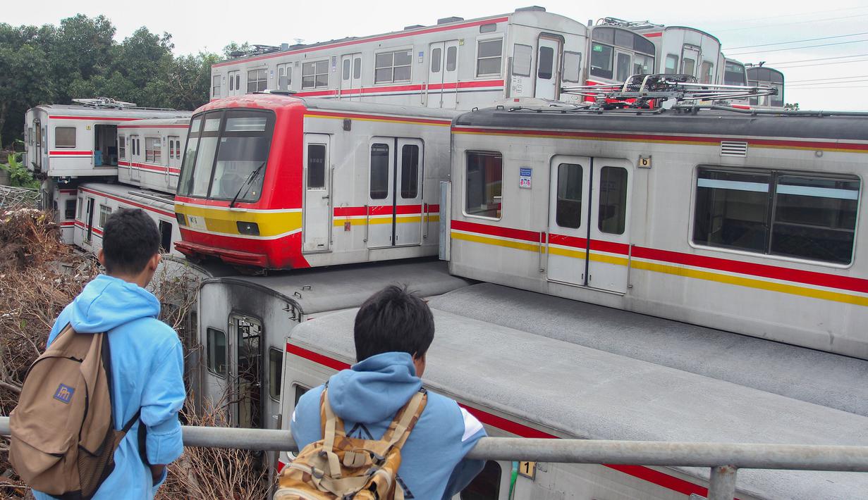 Proses tersebut merupakan langkah lanjutan dalam pengelolaan armada yang sudah tidak layak guna, sekaligus menjaga area depo tetap terkontrol sebelum pengiriman dilakukan secara bertahap. Tampak dalam foto, warga melihat-lihat tumpukan Kereta Rel Listrik (KRL) afkir di Depo Depok, Jalan Kampung Rawageni, Cipayung, Kota Depok, Jawa Barat, Selasa (20/01/2026). (Merdeka.com/Arie Basuki)
