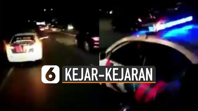 Beredar video kejar-kejaran mobil polisi dengan truk di tol. Truk itu tidak mau kalah dan justru seperti menantang mobil polisi tersebut.