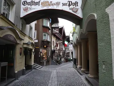 Bendera Italia digantung di sebuah restoran yang tutup di jalan sepi di Kufstein, Austria, Selasa (17/11/2020). Pemerintah Austria telah memberlakukan pengetatan aturan covid-19 yang mencakup penutupan sekolah dan toko-toko nonesensial seiring gelombang kedua virus corona. (AP/Matthias Schrader)