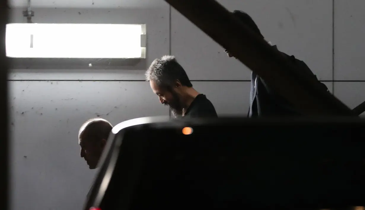 Jurnalis Jepang Jumpei Yasuda (tengah) berjalan saat tiba dari Istanbul di bandara Narita di Prefektur Chiba (25/10). Jumpei Yasuda diculik saat berada di Suriah utara sejak Juni 2015. (AFP Photo/Behrouz Mehri)