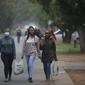 Mahasiswa Universitas Teknologi Tshwane kembali ke tempat tinggal mereka di Pretoria, Sabtu (27/11/2021). Saat dunia bergulat dengan munculnya varian baru COVID, para ilmuwan di Afrika Selatan —tempat Omicron diidentifikasi— berjuang memerangi penyebarannya ke seluruh negeri (AP Photo/Denis Farrell)