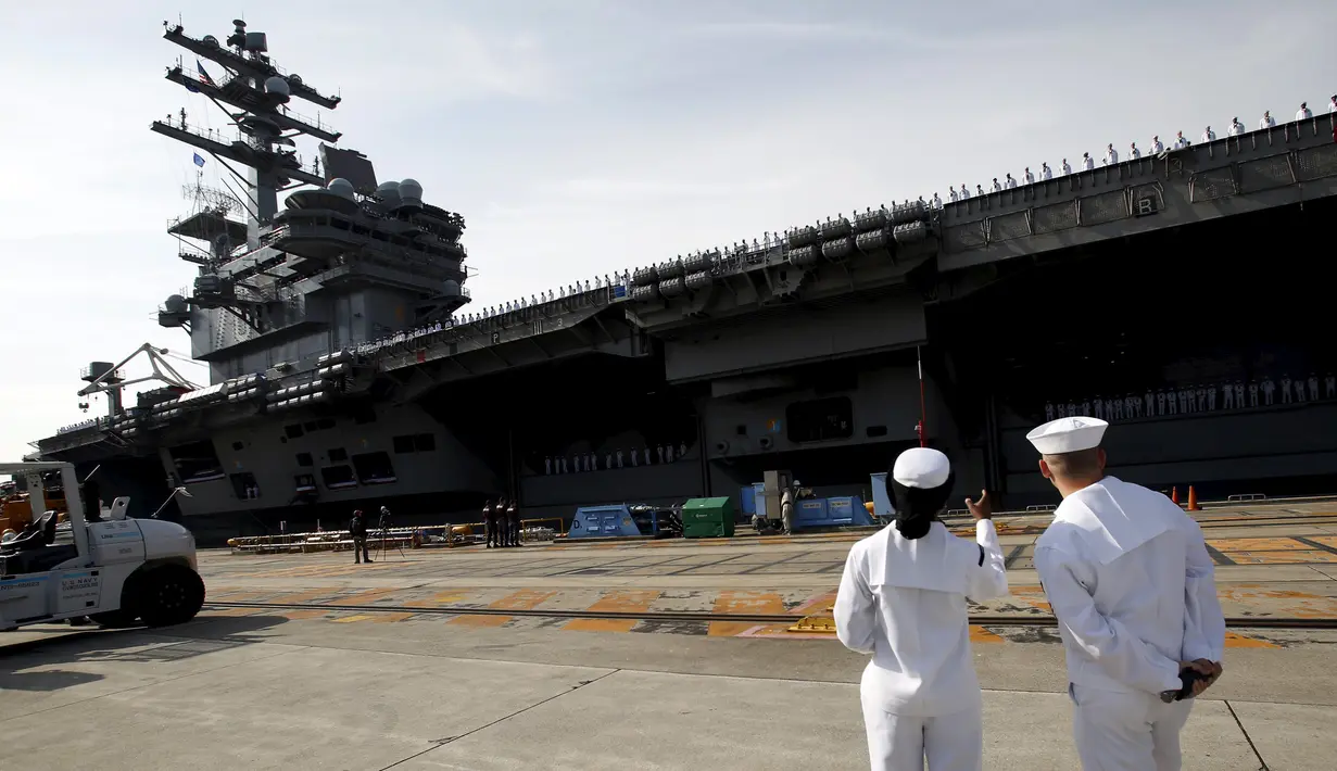 Prajurit Angkatan Laut AS terlihat menyaksikan USS Ronald Reagan kapal pembawa nuklir di pangkalan Angkatan Laut AS di Yokosuka, Tokyo, Jepang (1/10/2015). USS Ronald Reagan tiba di Jepang sehari lebih awal dari yang dijadwalkan. (REUTERS/ Yuya Shino)
