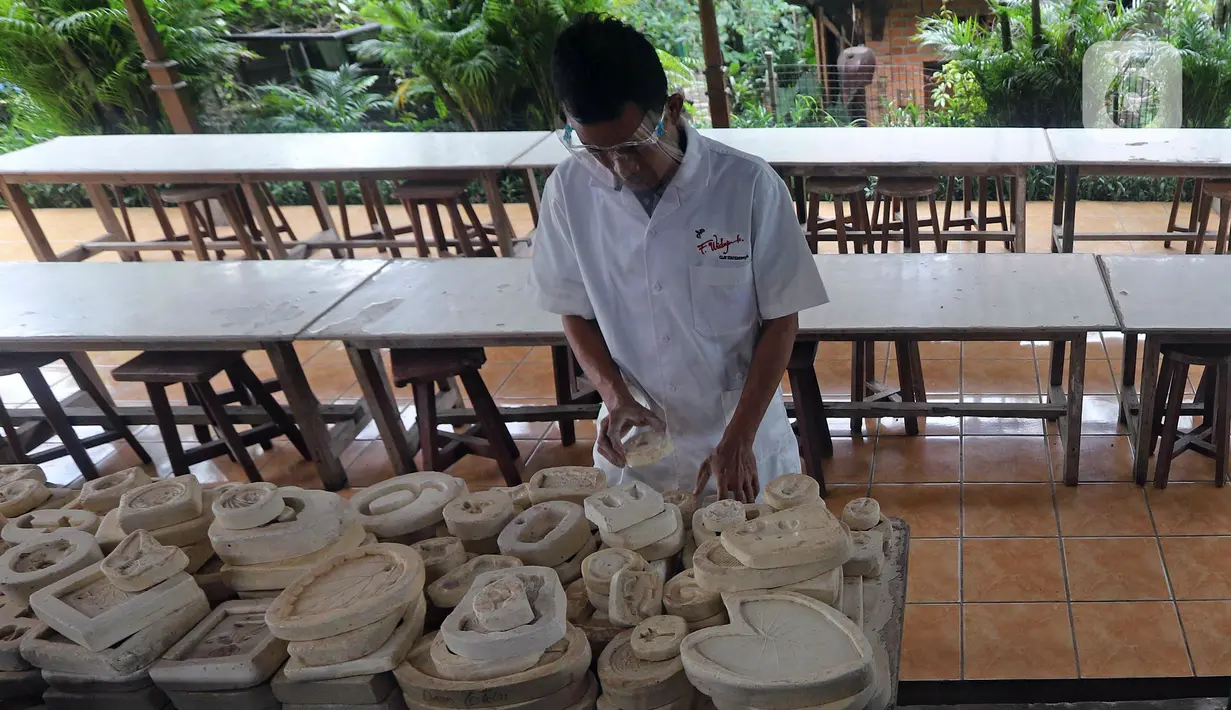 Pekerja memeriksa keramik hias aneka bentuk di Studio Workshop Rumah Keramik F Widayanto, Tanah Baru, Beji, Kota Depok, Jawa Barat, Rabu (18/11/2020). Variasi harga keramik hias produksi Rumah Keramik F Widayanto tergantung ukuran, model, dan tingkat kesulitan. (Liputan6.com/Herman Zakharia)