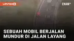 Aksi sebuah mobil berjalan mundur di jalan layang mengundang perhatian