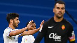 Gol kedua Los Blancos terjadi pada menit ke-24. Memanfaatkan bola rebound hasil tembakan crossing Rodrygo, Marco Asensio (kiri) sukses membobol gawang Reina. (AFP/Gabriel Bouys)